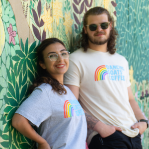 two people wearing pride 2024 shirts in natural and sport grey